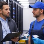 Data center manager and cleaning technician discussing data center cleaning plan.