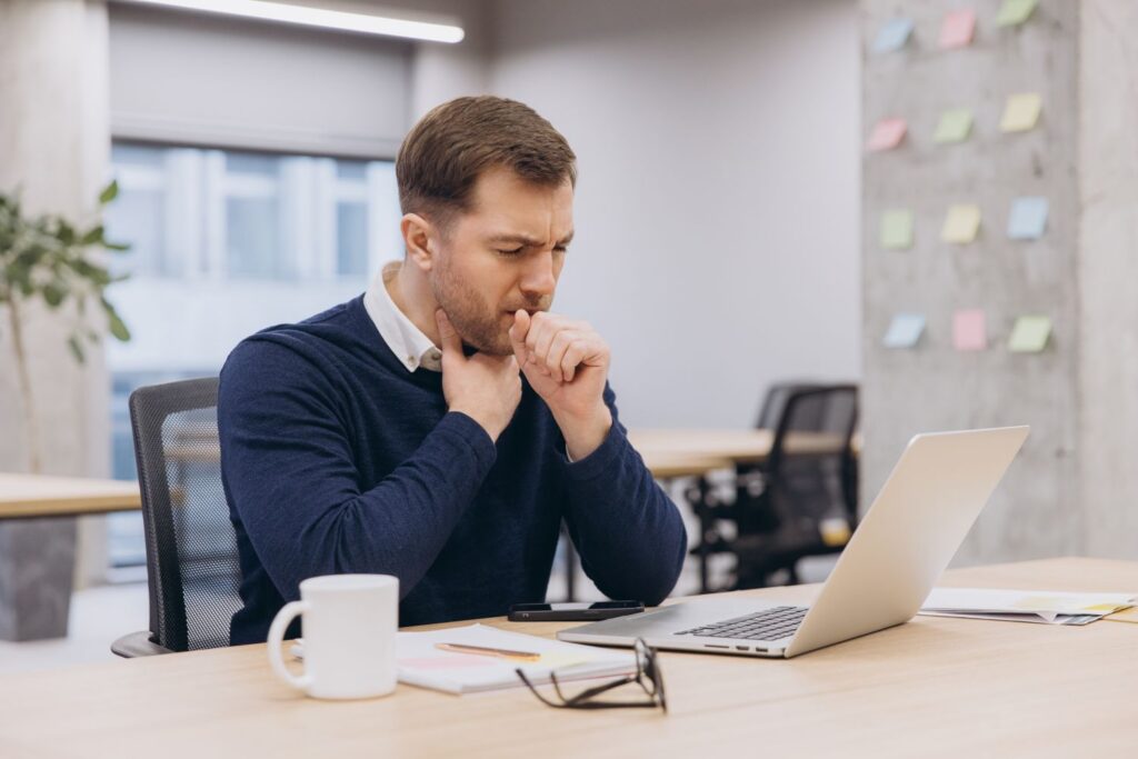 Sick employee from dust and allergen buildup in the office; this is a sign the office may need professional regular and deep cleaning.